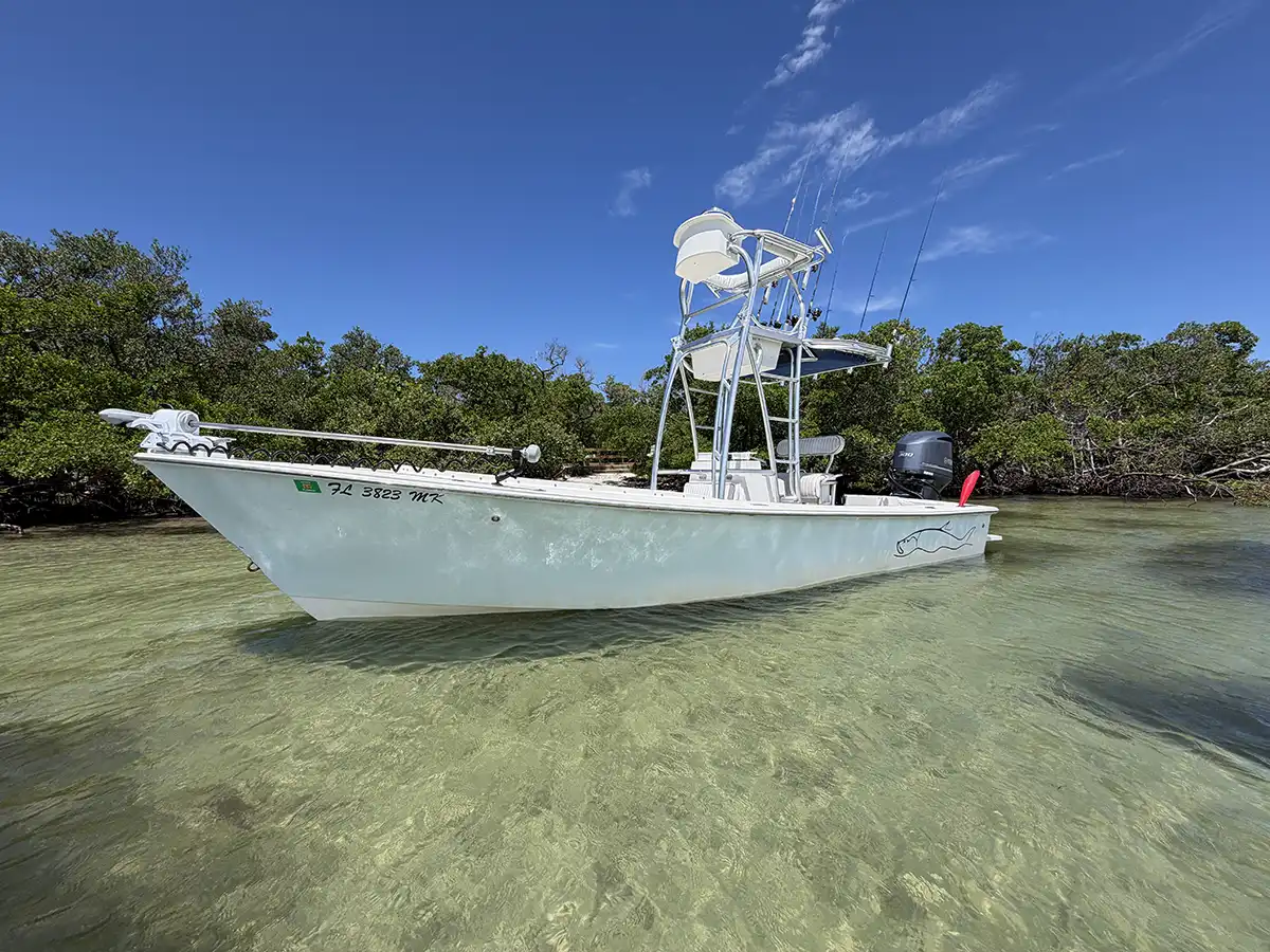 Fishing charter boat with tower and equipment in shallow water near Sarasota, Florida
